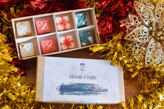 Box of Thistle Crafts Christmas Collection with decorative tinsel and ornaments.